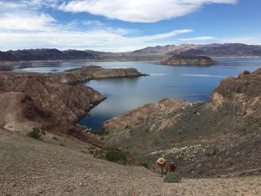 AZGS geoscientists ascending slope to exposure of fault in bedrock